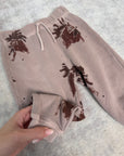 Pantaloni rosa stampa galli