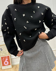 Felpa girocollo in neoprene nera con cabochon - Icona