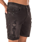 Shorts in jeans neri con schizzi e strappi