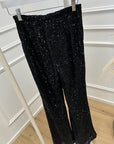 Pantaloni in paillettes neri a zampa